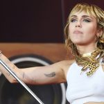 Miley Cyrus Takes the Stage in a Graphic Tee, Short Shorts & Metallic Go-Go Boots at Lollapalooza