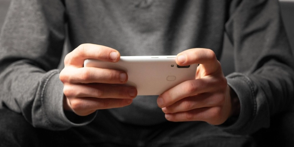 Man playing a game on a mobile phone